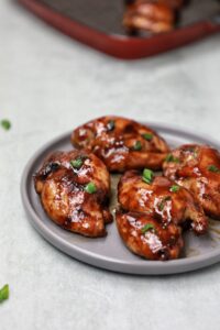5 pieces Teriyaki chicken thighs on a plate.