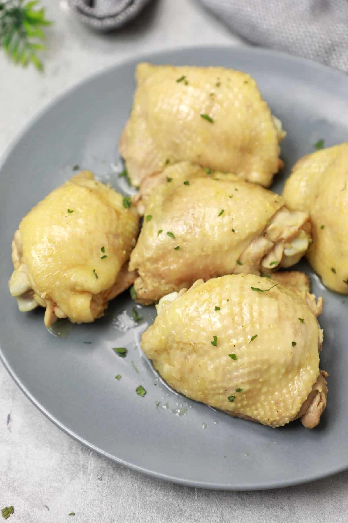 the cooked chicken served on a grey coloured plate.