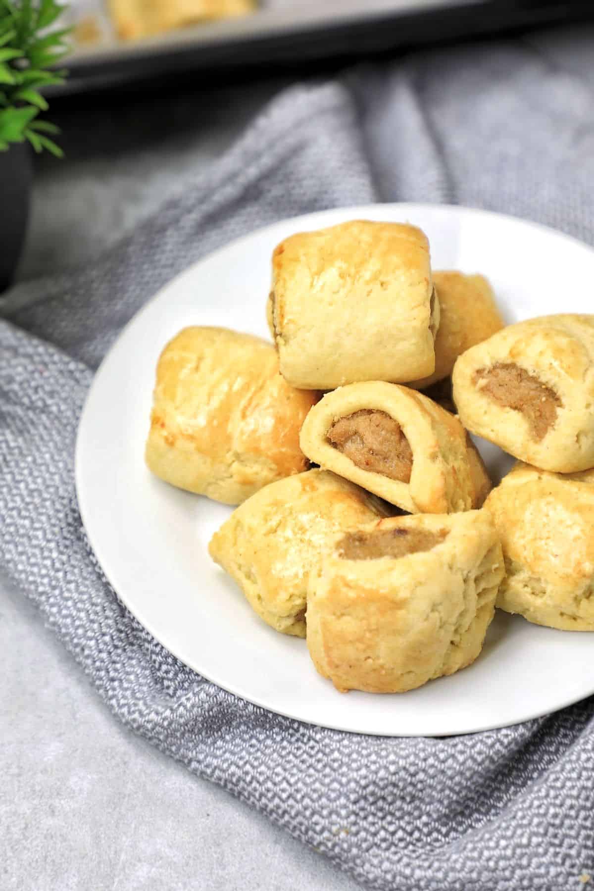 mini chicken sausage rolls on a plate.