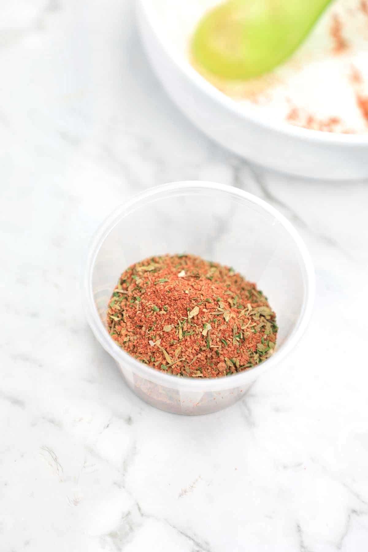 the seasoning in a plastic spice container.