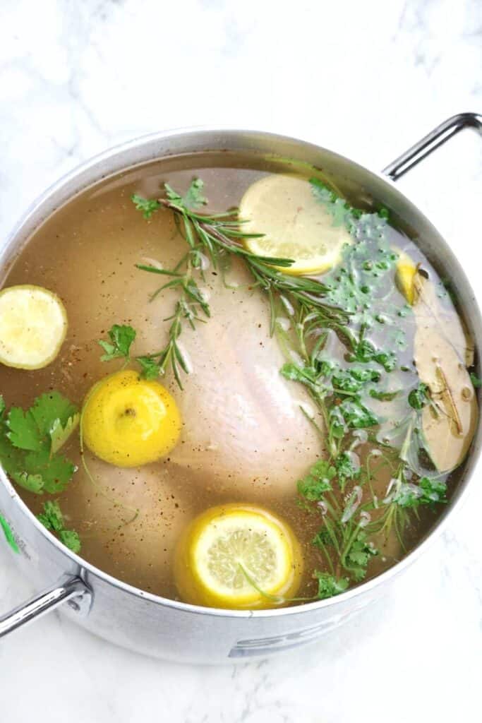 The brine and chicken in a pot.