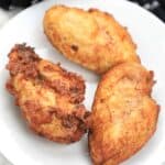 3 pieces fried chicken breasts on a plate.