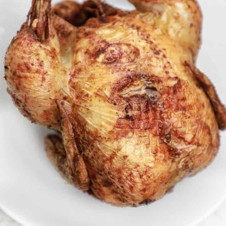 fried whole chicken on a plate.