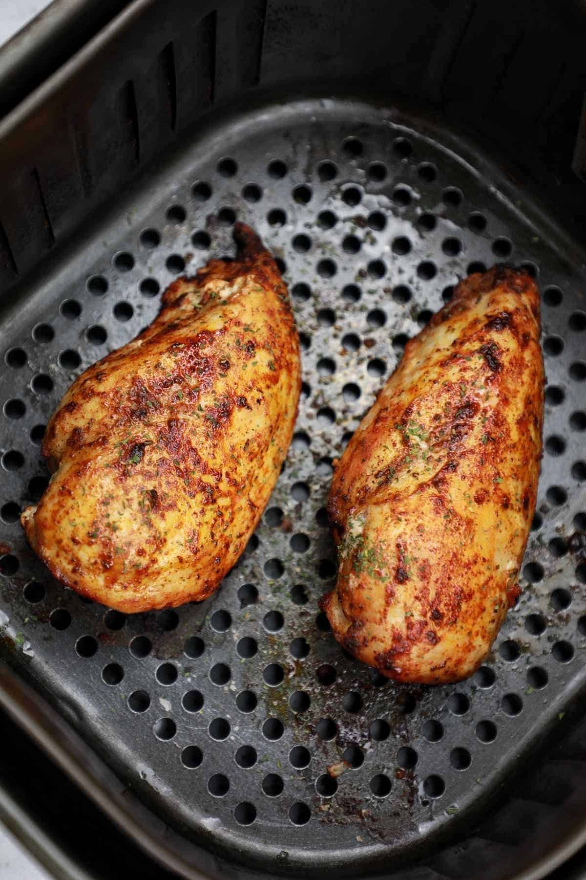 the cooked chicken displayed in the air fryer.