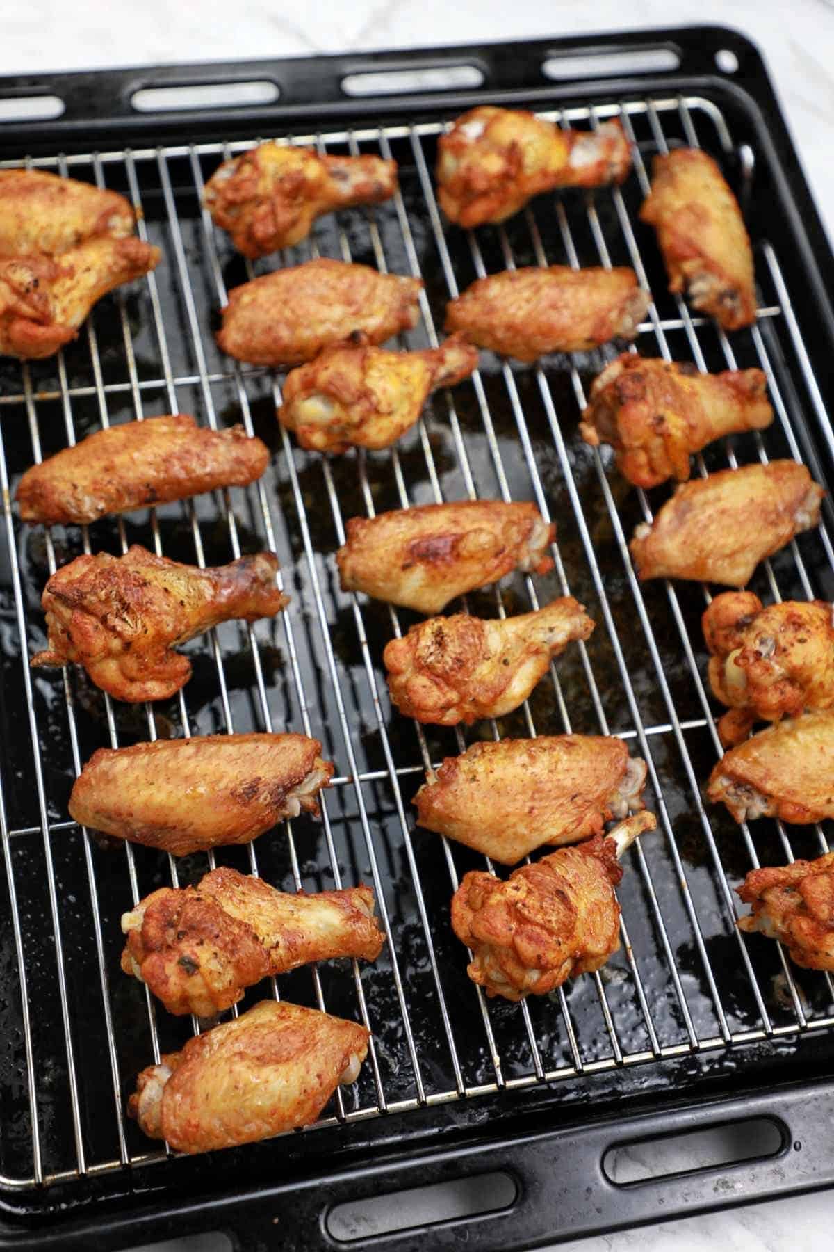 baked crispy wings on a baking tray.