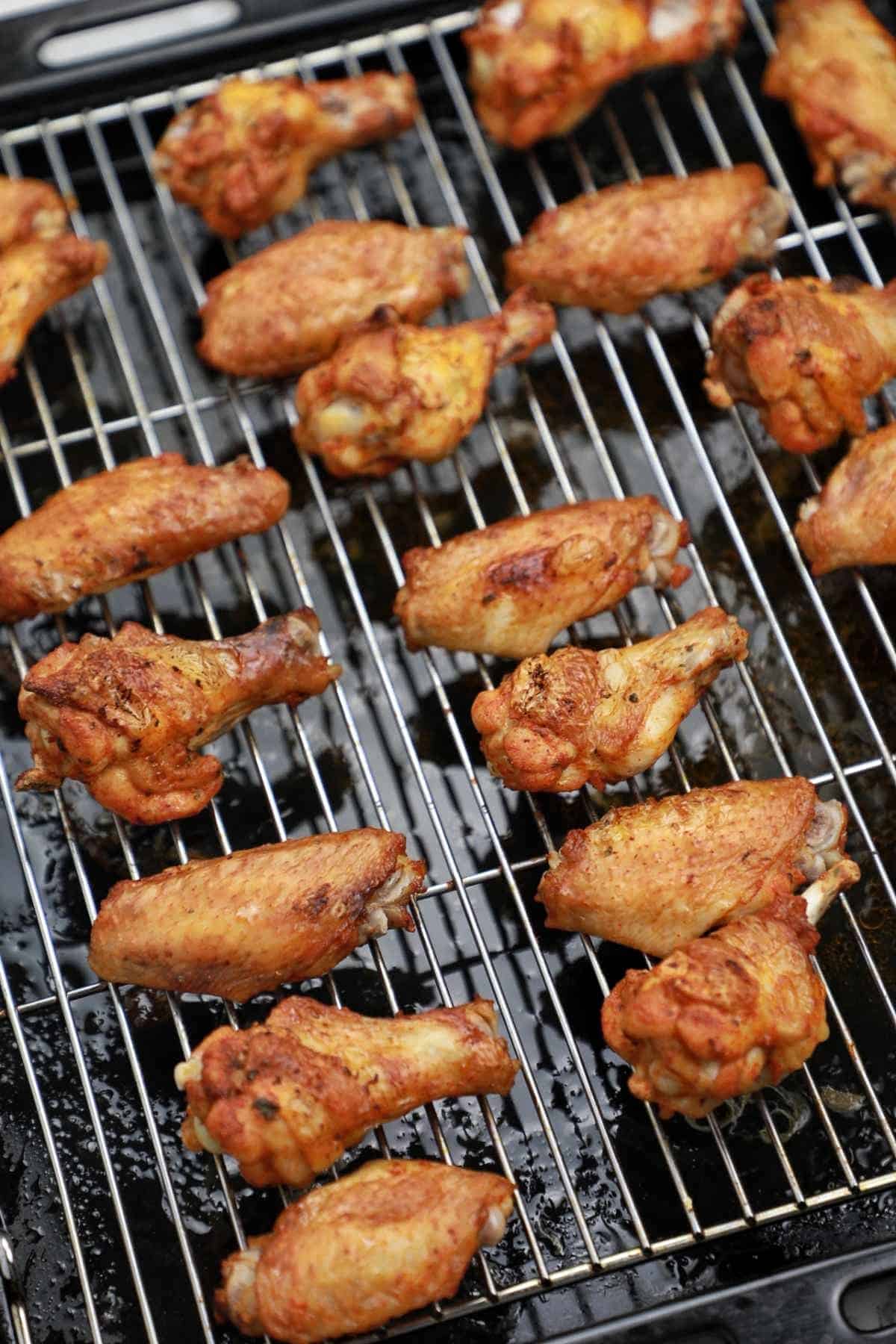 cooked wings on a baking rack.