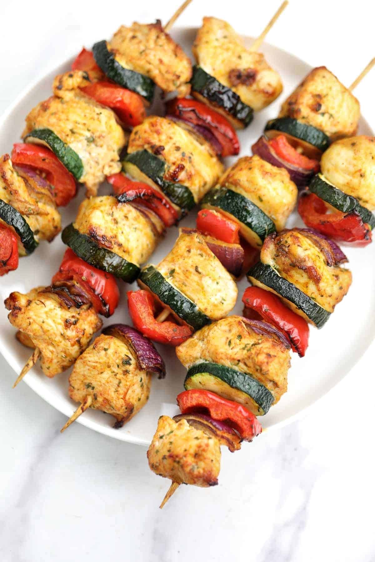 air fryer chicken kabobs served on a white plate.