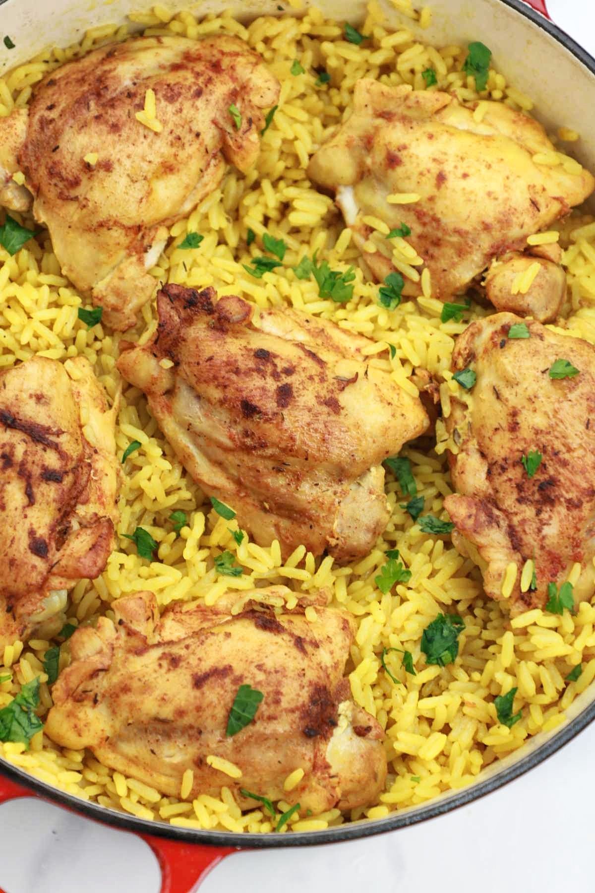 chicken and yellow rice in a pot.