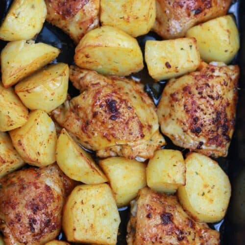 baked chicken and potatoes in a baking pan.