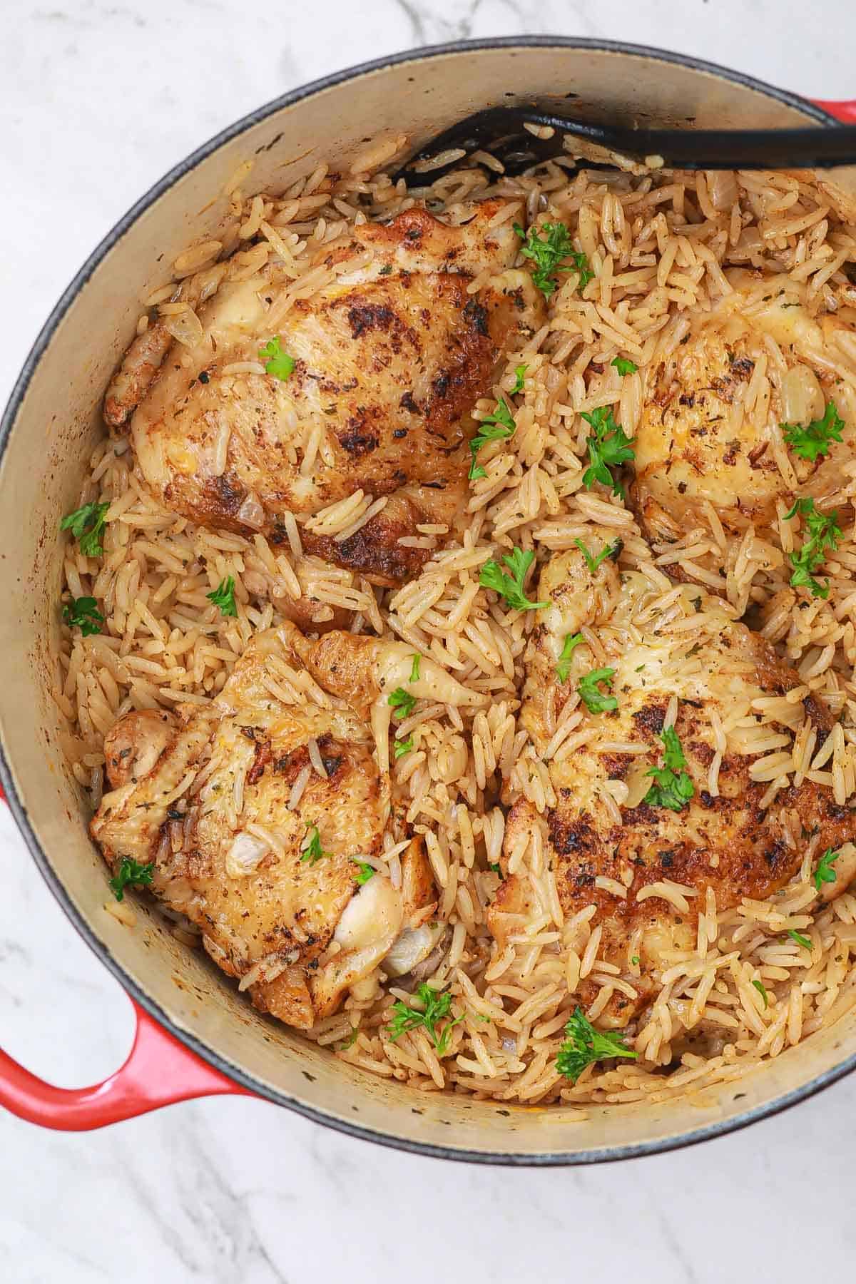 cooked chicken thighs and rice in one pot.