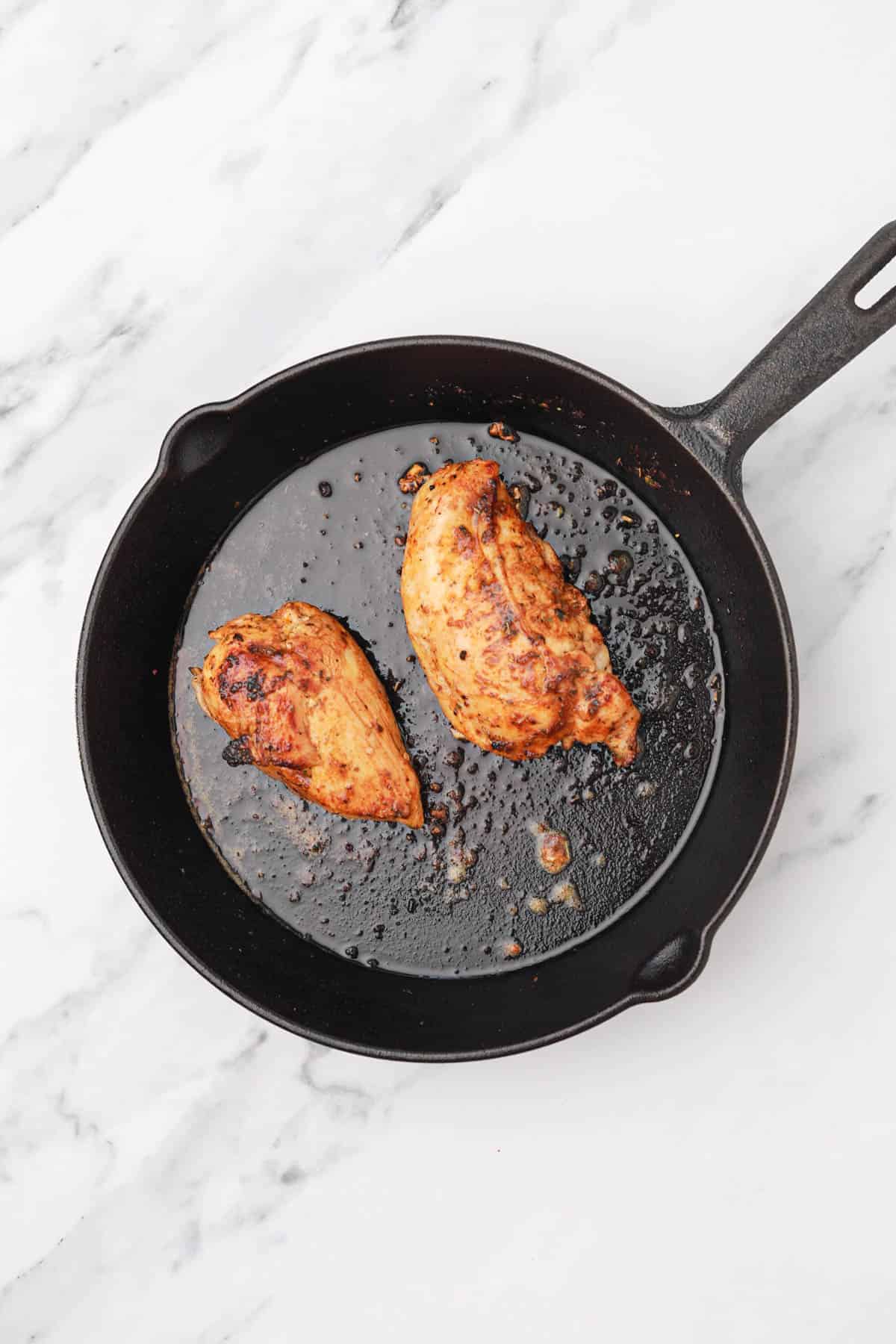 pan cooked chicken breast in a skillet.