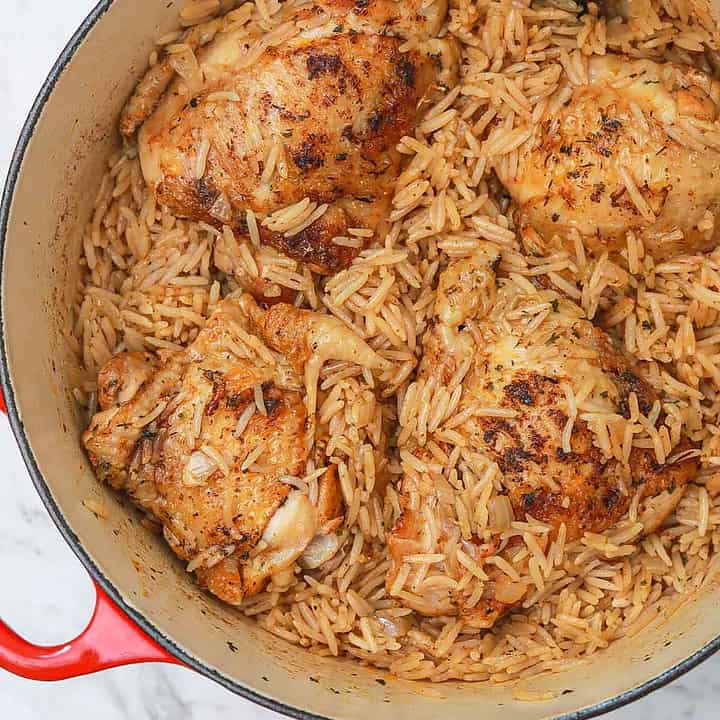 chicken thighs and rice in a pot.