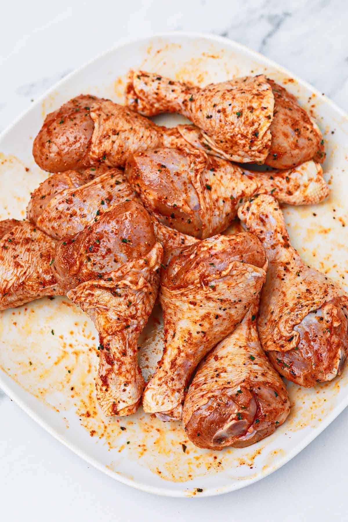 marinated drumsticks on a plate.