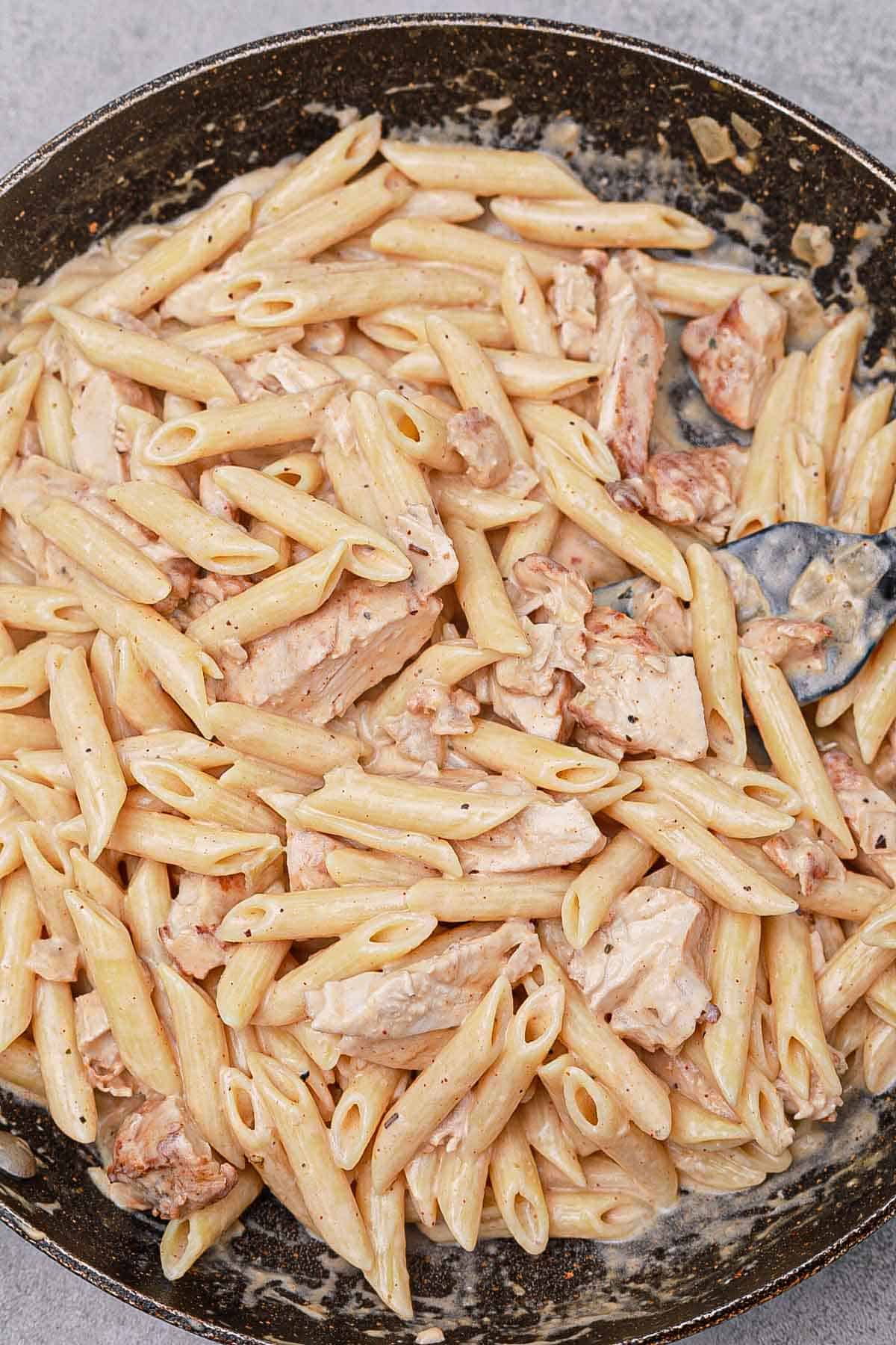 cooked Philadelphia cream cheese chicken pasta in a pan.